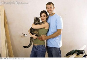couple_doing_diy_at_home_woman_holding_domestic_cat_man_embracing_woman_smiling_portrait_2905